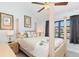 Comfortable bedroom with a four-poster bed, ceiling fan, and a view of the canal at 3825 Barnegat Dr, Punta Gorda, FL 33950