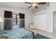 Bright bedroom with a ceiling fan, closet, and large window providing natural light at 3825 Barnegat Dr, Punta Gorda, FL 33950