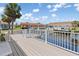 Waterfront home featuring a spacious deck with white railings, overlooking the canal and boat docks at 3825 Barnegat Dr, Punta Gorda, FL 33950