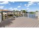 Waterfront home featuring a spacious deck with white railings, overlooking the canal and boat docks at 3825 Barnegat Dr, Punta Gorda, FL 33950