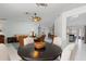 Open-concept dining area with seating for four and views to the living room at 3825 Barnegat Dr, Punta Gorda, FL 33950