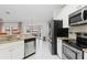 Bright kitchen with stainless appliances, granite countertops, and tile flooring at 3825 Barnegat Dr, Punta Gorda, FL 33950