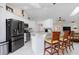Bright kitchen featuring white cabinets, stainless steel appliances, and bar seating at 3825 Barnegat Dr, Punta Gorda, FL 33950