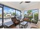 Inviting screened lanai with wicker furniture offering views of the canal at 3825 Barnegat Dr, Punta Gorda, FL 33950