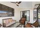 Relaxing screened lanai with wicker furniture, ceiling fan, and views of the outdoors at 3825 Barnegat Dr, Punta Gorda, FL 33950