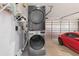 Convenient laundry area with stacked washer and dryer in the garage at 3825 Barnegat Dr, Punta Gorda, FL 33950