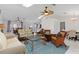 Bright living room featuring vaulted ceilings with skylights, a ceiling fan, and an open layout to the dining area at 3825 Barnegat Dr, Punta Gorda, FL 33950
