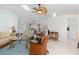 Bright living room featuring vaulted ceilings with skylights, a ceiling fan, and an open layout to the dining area at 3825 Barnegat Dr, Punta Gorda, FL 33950