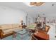 Bright living room featuring vaulted ceilings with skylights, a ceiling fan, and an open layout to the dining area at 3825 Barnegat Dr, Punta Gorda, FL 33950