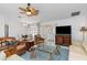 Light and airy living room featuring a ceiling fan, television, and comfortable seating at 3825 Barnegat Dr, Punta Gorda, FL 33950