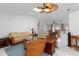 Bright living room featuring vaulted ceilings with skylights, a ceiling fan, and an open layout to the dining area at 3825 Barnegat Dr, Punta Gorda, FL 33950