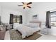 Spacious main bedroom featuring a ceiling fan, and two windows for great natural light at 3825 Barnegat Dr, Punta Gorda, FL 33950