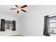 Bright bedroom with ceiling fan and large windows bringing in natural light at 3825 Barnegat Dr, Punta Gorda, FL 33950