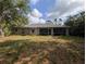 Home's rear exterior showing the screened in patio and large yard at 4205 Simkins Ave, North Port, FL 34286