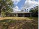 A view of the backyard and screened in porch from the outside at 4205 Simkins Ave, North Port, FL 34286