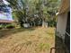 Lush backyard with mature trees providing shade and privacy, perfect for outdoor activities and relaxation at 4205 Simkins Ave, North Port, FL 34286