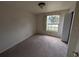 Clean bedroom features a large window with bright natural light and a closet at 4205 Simkins Ave, North Port, FL 34286