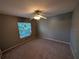 This cozy bedroom features a ceiling fan and a window providing ample natural light at 4205 Simkins Ave, North Port, FL 34286