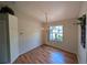 Bright dining room features hardwood floors, a chandelier, and a window overlooking the front yard at 4205 Simkins Ave, North Port, FL 34286