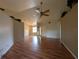 A spacious living room features gleaming hardwood floors and a stylish ceiling fan at 4205 Simkins Ave, North Port, FL 34286