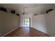 Bright open concept living room features wood floors and sliding glass doors to the backyard at 4205 Simkins Ave, North Port, FL 34286