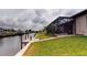 Beautifully landscaped backyard overlooking canal with pilings, dock and outdoor shower at 4426 Vasco St, Punta Gorda, FL 33950