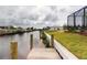 Backyard canal view with wooden pilings and manicured lawn at 4426 Vasco St, Punta Gorda, FL 33950