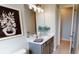 Clean bathroom featuring modern lighting, a vanity with gray cabinets, and neutral wall decor at 4426 Vasco St, Punta Gorda, FL 33950