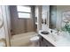 Well-lit bathroom with modern fixtures, a tiled shower and bathtub, and stylish decor at 4426 Vasco St, Punta Gorda, FL 33950
