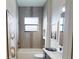 Modern bathroom featuring tiled walls, a bathtub, and contemporary fixtures at 4426 Vasco St, Punta Gorda, FL 33950
