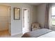 Relaxing bedroom showcasing an inviting chair and a peek into the ensuite bathroom at 4426 Vasco St, Punta Gorda, FL 33950