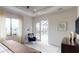 Relaxing bedroom with pool view, accent chair, and neutral tones at 4426 Vasco St, Punta Gorda, FL 33950