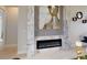Close-up of a modern fireplace with marble and gray tile accents in the living space at 4426 Vasco St, Punta Gorda, FL 33950