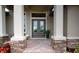 Elegant front entrance featuring a double door, stone accents, columns and tiled entryway at 4426 Vasco St, Punta Gorda, FL 33950