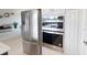 Modern kitchen featuring stainless steel appliances, built-in oven, and ample storage space in white cabinetry at 4426 Vasco St, Punta Gorda, FL 33950