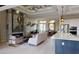 Spacious living room with fireplace, coffered ceilings, modern decor, and open layout with an island counter at 4426 Vasco St, Punta Gorda, FL 33950