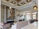 Open living space with a fireplace, stylish ceiling fan, dining area and neutral furnishings at 4426 Vasco St, Punta Gorda, FL 33950