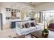 Open-concept living room with a modern kitchen, coffered ceiling, and sliding glass doors to the outdoor space at 4426 Vasco St, Punta Gorda, FL 33950