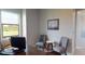 Functional office space featuring a desk with computer setup, accent chairs, and natural light at 4426 Vasco St, Punta Gorda, FL 33950