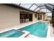 Relaxing screened pool and spa, with outdoor kitchen and dining area at 4426 Vasco St, Punta Gorda, FL 33950