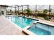 Enclosed screened pool with tile surround, canal view and tropical landscaping at 4426 Vasco St, Punta Gorda, FL 33950