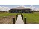 Idyllic backyard view featuring a charming wooden dock and a well-maintained lawn leading up to the home at 5061 Collingswood Blvd, Port Charlotte, FL 33948