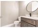 Powder room featuring marble countertop, modern faucet, and dark wood vanity at 5061 Collingswood Blvd, Port Charlotte, FL 33948