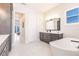 Bright bathroom featuring double vanity, soaking tub, and bright views at 5061 Collingswood Blvd, Port Charlotte, FL 33948