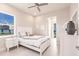 Bright bedroom with large window, white furniture, and neutral decor at 5061 Collingswood Blvd, Port Charlotte, FL 33948