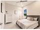 Neutral bedroom featuring modern decor, large window, and bright lighting at 5061 Collingswood Blvd, Port Charlotte, FL 33948