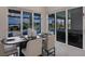 Dining room features large sliding glass doors offering views of the pool and canal at 5061 Collingswood Blvd, Port Charlotte, FL 33948