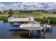 Picturesque view of a private boat lift and dock, providing easy access to the water from this beautiful home at 5061 Collingswood Blvd, Port Charlotte, FL 33948