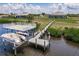 Scenic view featuring a boat lift and dock, offering convenient access to waterfront activities at 5061 Collingswood Blvd, Port Charlotte, FL 33948