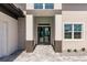 Elegant home entrance with a stone walkway and double glass doors at 5061 Collingswood Blvd, Port Charlotte, FL 33948